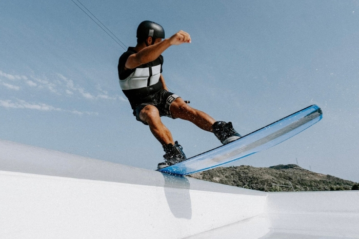 Man wakeboarding wearing a Mystic impact vest